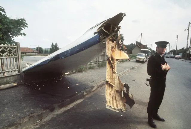 A policeman guards the wreckage of the Tupolev 144 that crashed during the Paris Air Show, killing all six on board and eight on the ground, destroying 15 houses in Goussainville, near Le Bourget airport, 04 June 1973. The Tupolev Tu-144 was the first Soviet supersonic transport aircraft, constructed under the direction of the Soviet Tupolev design bureau headed by Alexei Tupolev. (Photo by AFP Photo)
