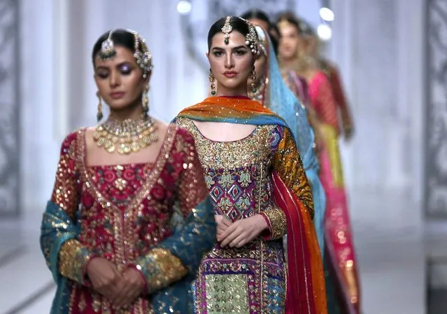 Models present creations by a designer Haris Shakeel during Bridal Couture Week, in Lahore, Pakistan, Friday, December 10, 2021. (Photo by K.M. Chaudary/AP Photo) 