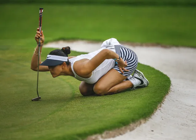 Michelle Wie of the USA checks the green on the eighth during the third round of the HSBC Women's Champions golf tournament in Singapore, March 4, 2017. (Photo by Wallace Woon/EPA)