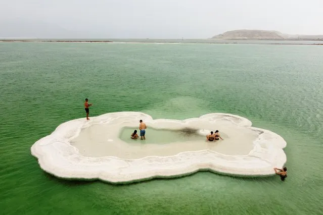 Visitors explore a salt formation in the Dead Sea near Ein Bokeq, Israel, October 30, 2021.Picture taken with a drone. (Photo by Amir Cohen/Reuters)