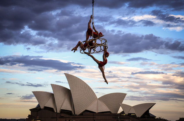 Trapeze performers hang from a cable in front of the Sydney Opera House as part of an Australia Day show titled the “Wedding of the Winds” on January 26, 2021 in Sydney, Australia. Australia Day, formerly known as Foundation Day, is the official national day of Australia and is celebrated annually on January 26 to commemorate the arrival of the First Fleet to Sydney in 1788. Indigenous Australians refer to the day as 'Invasion Day' and there is growing support to change the date to one which can be celebrated by all Australians. (Photo by James D. Morgan/Getty Images)