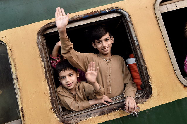 Children wave from a train's window as they prepare to travel to their homes to celebrate Eid al-Fitr, in Karachi, Pakistan, 07 April 2024. Eid al-Fitr is an Islamic holiday that marks the end of Ramadan, and is celebrated during the first three days of Shawwal, the 10th month of the Islamic calendar. It is expected to begin on 10 or 11 April 2024, depending on the lunar calendar. The Muslims' holy month of Ramadan is the ninth month in the Islamic calendar and it is believed that the revelation of the first verse in the Koran was during its last 10 nights. It is celebrated yearly by praying during the night time and abstaining from eating, drinking, and sexual acts during the period between sunrise and sunset. It is also a time for socializing, mainly in the evening after breaking the fast and a shift of all activities to late in the day in most countries. (Photo by Shahzaib Akber/EPA)