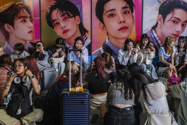 Fans queue up to buy the new album “17 is Right Here”, by South Korean boy band Seventeen (or SVT), outside a convenience store in the trendy Hongdae neighbourhood of Seoul on April 29, 2024, on the day of the album's official release. (Photo by Anthony Wallace/AFP Photo)