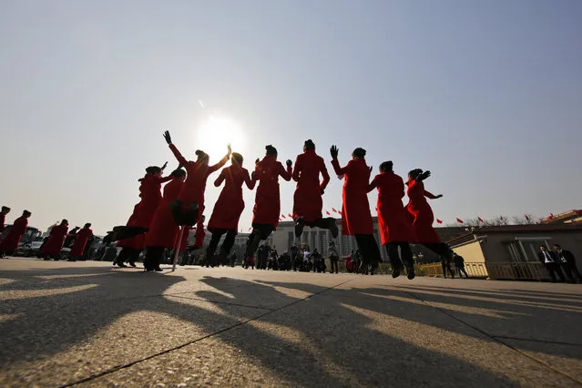 In this Friday, March 3, 2017 photo, hospitality staff jump as they pose for photographs on Tiananmen Square during the Chinese People's Political Consultative Conference (CPPCC) held at the Great Hall of the People in Beijing. (Photo by Andy Wong/AP Photo)