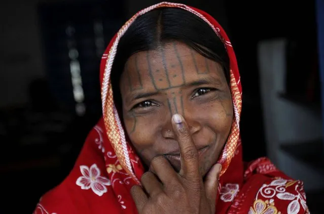 An indigenous woman belonging to the Kandha tribe has ink mark on her index finger after casting her vote at a polling station during Indian parliamentary elections  at Kutamgarh village in Kandhamal district, Orissa state, India, Thursday, April 10, 2014. Millions of people are voting in the third phase of the elections Thursday, covering parts of 11 of India's 28 states.  (Photo by Biswaranjan Rout/AP Photo)