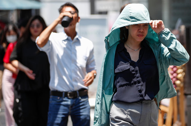 A woman shields herself from sunlight during hot weather in Bangkok, Thailand, 02 April 2024. The Meteorological Department issued a public warning of hot and extremely hot weather in Thailand with the weather forecasts of the highest temperature possibly reaching 43.0 to 44.5 degrees Celsius in the North, Northeast, upper parts of the Central Plains, and the East regions of the country which is about 30 percent higher average temperature than normal levels. (Photo by Rungroj Yongrit/EPA/EFE)