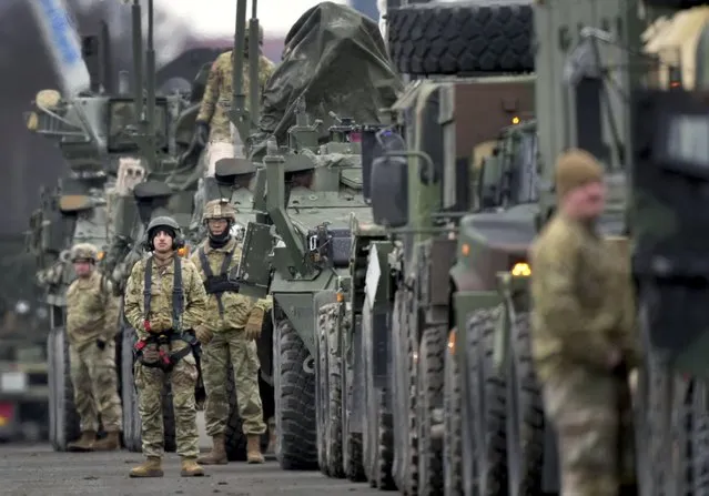 Soldiers of the 2nd Cavalry Regiment line up vehicles at the military airfield in Vilseck, Germany, Wednesday, February 9, 2022 as they prepare for the regiment's movement to Romania loading of Stryker combat vehicles for their deployment to support NATO allies and demonstrate U.S. commitment to NATO Article V. The soldiers will deploy to Romania in the coming days from their post in Vilseck and will augment the more than 900 U.S. service members already in Romania. This Stryker Squadron represents a combined arms unit of lightly armored, medium-weight wheeled combat vehicles. (Photo by Michael Probst/AP Photo)