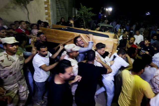 People react as the coffin of Islam Ibrahim Abdel Razeq, Egyptian army soldier killed in Rafah, is transported, in his hometown, in Fayoum, Egypt on May 28, 2024. (Photo by Amr Abdallah Dalsh/Reuters)