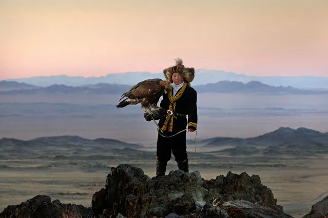 13 year old Ashol Pan with her eagle – Despite her young age, Ashol had the amazing ability to control and be able to caress her eagle, almost as if she had been with it for years. (Photo by Asher Svidensky/Caters News)