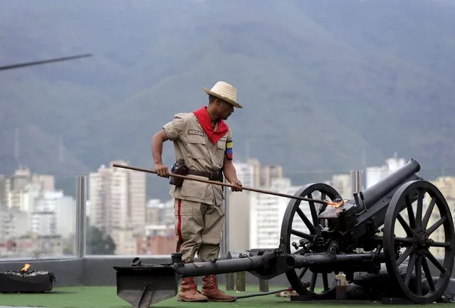 A soldier fires a cannon at 4:25 p.m., the time the death of Venezuela's late president Hugo Chavez was announced, at the 4F military fort in Caracas, June 30, 2015. (Photo by Jorge Dan Lopez/Reuters)