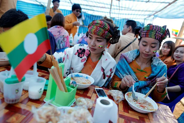 Ethnic Shan women eat their lunch as they celebrate the 69th Shan State National Day at Loi Tai Leng, the group's headquarters, on the Thai-Myanmar border February 7, 2016. (Photo by Soe Zeya Tun/Reuters)