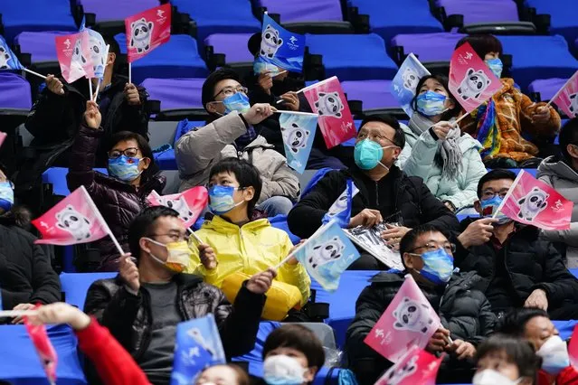 Spectators cheer during a preliminary round men's hockey game between China and Canada at the 2022 Winter Olympics, Sunday, February 13, 2022, in Beijing. (Photo by Matt Slocum/AP Photo)