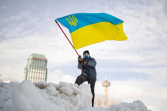 A boy waves a Ukrainian flag during a rally in support of Ukraine and against Russia, in Niagara Falls, Canada, January 30, 2022. (Photo by Nick Iwanyshyn/Reuters)