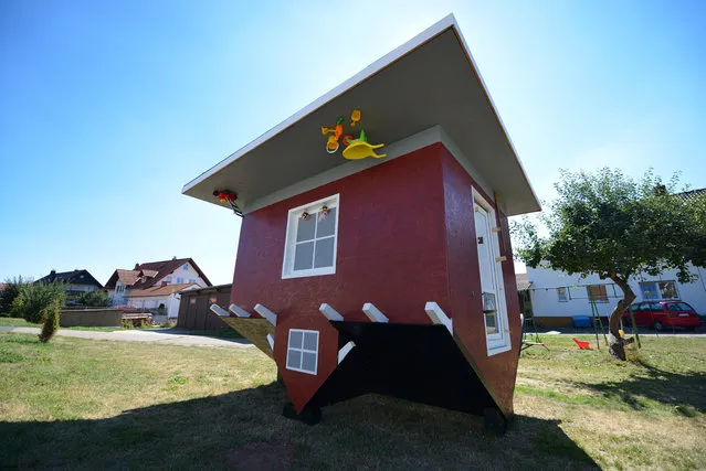 An upside down model of a house is build in Wellen, central Germany, on September 5, 2013. A full scaled house will be erected 2014 at the Edersee, central Germany. (Photo by Uwe Zucchi/AFP Photo/DPA)