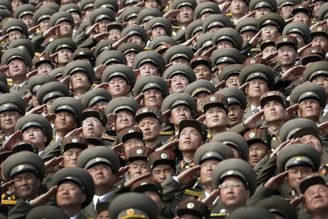 North Korean soldiers salute while the national anthem is played during a military parade on Saturday, April 15, 2017, in Pyongyang, North Korea to celebrate the 105th birth anniversary of Kim Il Sung, the country's late founder and grandfather of current ruler Kim Jong Un. (Photo by Wong Maye-E/AP Photo)