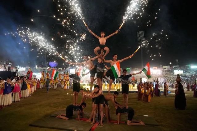 Students performs the traditional Mallakhamba during the inauguration of Khel Mahakumbh, a state level sporting event, in Ahmedabad, India, Saturday, March 12, 2022. (Photo by Ajit Solanki/AP Photo)