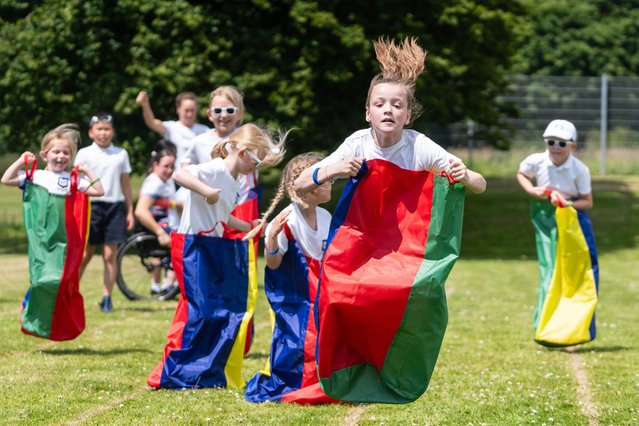 Year 4 pupil, Flo participates in the sack race during a “Positive Energy Sports Day”, at St. Augustine's Catholic Primary School in Hythe, Kent, organised in partnership between British Gas and Heart Radio on Tuesday, July 2, 2024. Photo by Niklas Halle'n/PA Media Assignments)