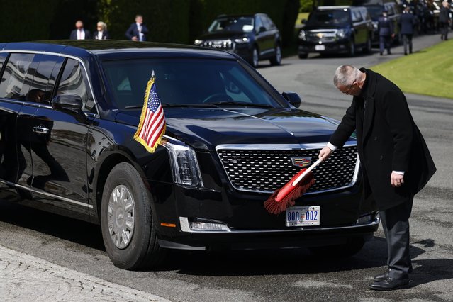 A person cleans The Beast, the US President's official car at Aras an Uachtarain, Residence of the President of Ireland, in Phoenix Park, Dublin, Ireland on April 13, 2023. This is the second day of a four-day visit by President Biden to Northern Ireland and the Republic of Ireland to mark the 25th anniversary of the Good Friday Agreement. (Photo by Tolga Akmen/EPA/EFE)