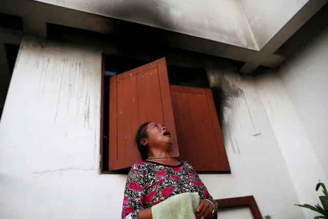 A woman cries in front of a burnt building at the Pitakkiat Wittaya School in the northern province of Chiang Rai, Thailand, May 23, 2016. (Photo by Athit Perawongmetha/Reuters)