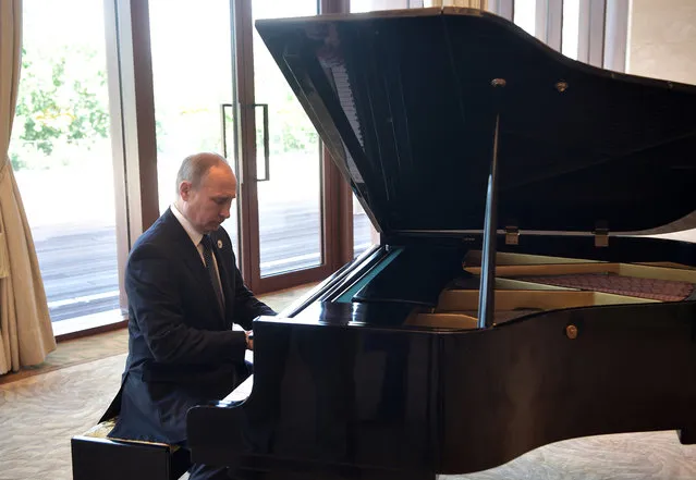 Russian President Vladimir Putin plays piano before his talks with Chinese President Xi Jinping prior to the opening ceremony of the Belt and Road Forum in Beijing, Sunday, May 14, 2017. (Photo by Alexei Nikolsky, Sputnik, Kremlin Pool Photo via AP Photo)