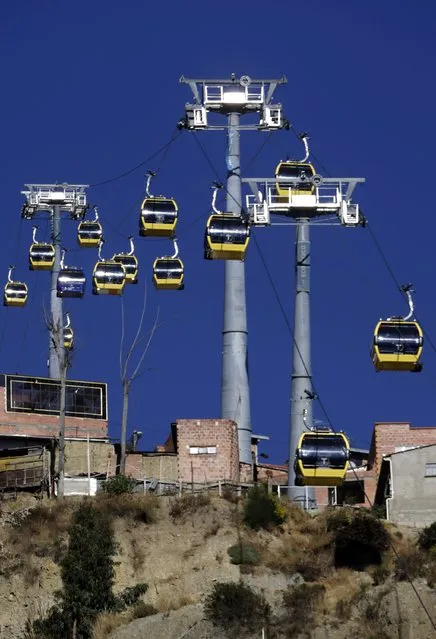 Cable cars pass over El Alto, July 23, 2015. (Photo by David Mercado/Reuters)