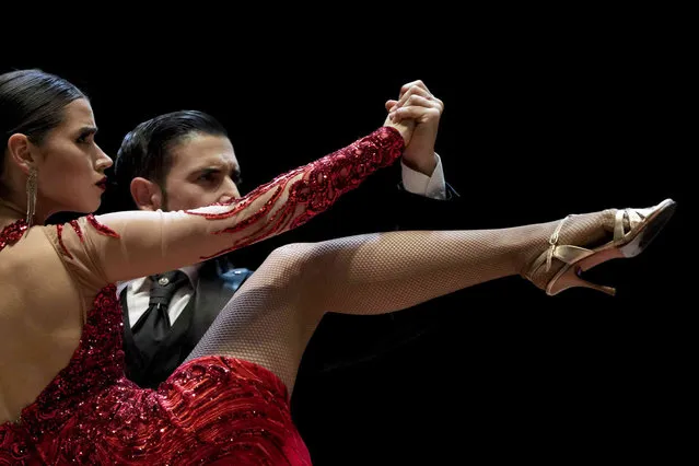 Ariel Almiron and Alumine Deluchi compete in the final round of the Tango World Championship stage category, in Buenos Aires, Argentina, Saturday, September 25, 2021. (Photo by Natacha Pisarenko/AP Photo)