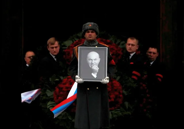 Pallbearers carry the coffin and a portrait of former mayor of Moscow Yuri Luzhkov out of the the Cathedral of Christ the Saviour after a memorial service, in Moscow, Russia on December 12, 2019. (Photo by Maxim Shemetov/Reuters)