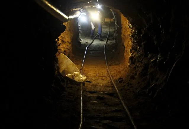 A journalist walks through a tunnel discovered by the Mexican Army, during a presentation to the media in Tijuana, Mexico August 2, 2015. According to local media, authorities found the tunnel, which is still under construction at the northern city of Tijuana which borders with the United States. (Photo by Jorge Duenes/Reuters)