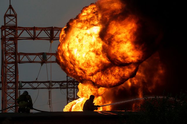 Rescue workers extinguish a fire of a burning electrical substation hit by a Russian bombing in Dnipropetrovsk region, Ukraine, Monday, September 2, 2024. (Photo by Evgeniy Maloletka/AP Photo)