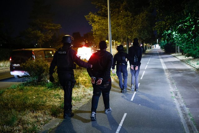 French Police detain teenagers during riot in Nanterre, near Paris, France, 28 June 2023. The violence broke out after police fatally shot a 17-year-old during a traffic stop in Nanterre. According to the French interior minister, 31 people were arrested with 2,000 officers being deployed to prevent further violence. (Photo by Yoan Valat/EPA/EFE/Rex Features/Shutterstock)