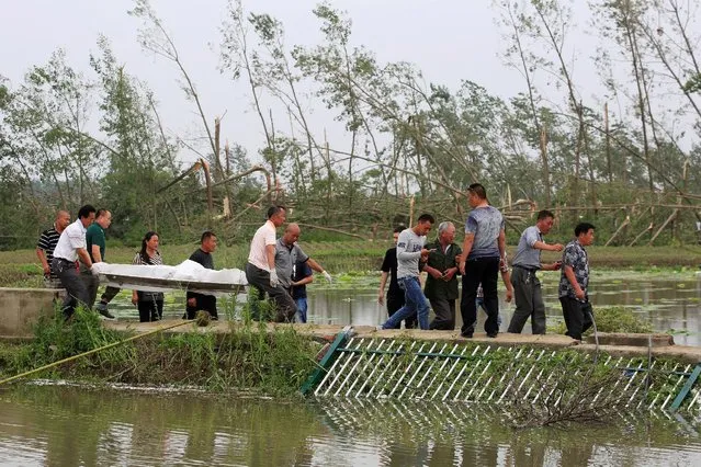 Rescue workers transport a body after a tornado hit Funing on Thursday, in Yancheng, Jiangsu province, China June 24, 2016. (Photo by Aly Song/Reuters)