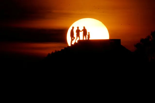 People enjoy the sunset in Vlora, Albania, May 4, 2022. (Photo by Florion Goga/Reuters)
