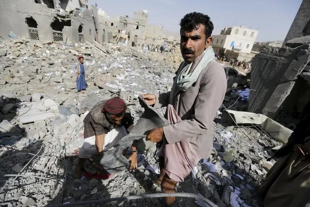 A Houthi militant holds a fragment of a missile as he searches the rubble of the offices of the education ministry's workers union, destroyed by Saudi-led air strikes, in Yemen's northwestern city of Amran August 19, 2015. (Photo by Khaled Abdullah/Reuters)