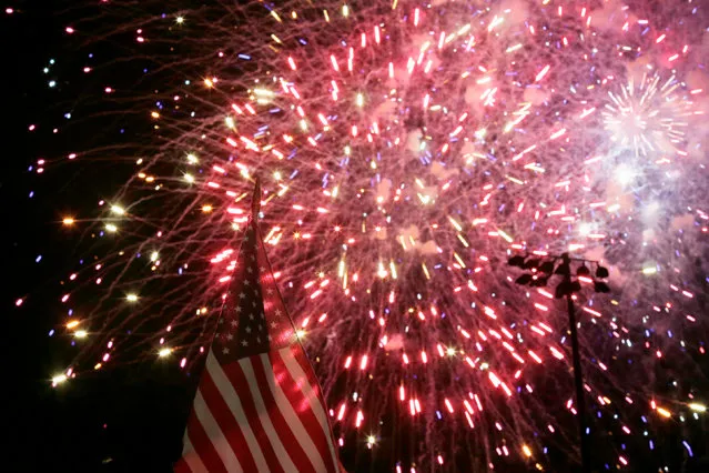 A U.S. flag flutters in the breeze as fireworks explode during U.S. Independence Day celebrations in Somerville, Massachusetts June 30, 2016, ahead of the July 4th holiday. (Photo by Brian Snyder/Reuters)