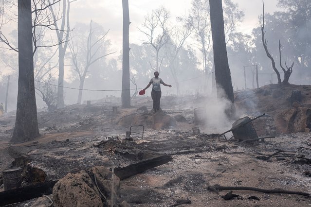 A resident of the Jakwa informal settlement guestures after a fire burned through around 300 shacks in Bryanston near Johannesburg on December 2, 2024. (Photo by Emmanuel Croset/AFP Photo)