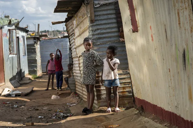 Children play in the Empiweni informal settlement in Soweto, near Johannesburg, South Africa, Wednesday March 25, 2020. South Africa will go into a nationwide lockdown for 21 days starting Friday morning, in an effort to mitigate the spread to the coronavirus. (Photo by Jerome Delay/AP Photo)