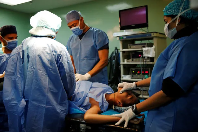 A patient lies on a bed during sterilization surgery in the operating room of a hospital in Caracas, Venezuela July 27, 2016. (Photo by Carlos Garcia Rawlins/Reuters)