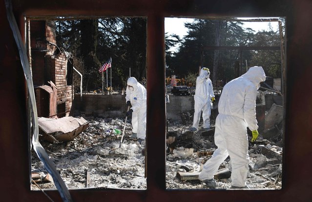 Nick Sonnenberg and his parents search for personal items to recover from the remains of his apartment which burned in the Eaton Fire on January 25, 2025 in Altadena, California. Multiple wildfires fueled by intense Santa Ana Winds burned across Los Angeles County leaving at least 28 dead with over 180,000 people having been under evacuation orders. Over 12,000 structures, many of them homes and businesses, burned in the Palisades and Eaton Fires. President Donald Trump surveyed wildfire damage yesterday and pledged to 'open the coffers' for federal aid to California. (Photo byu Mario Tama/Getty Images/AFP Photo)