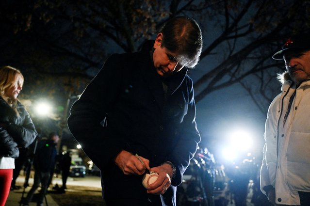 Former Illinois Governor Rod Blagojevich, a Democrat and former contestant on “The Celebrity Apprentice”, who was convicted of corruption for trying to sell former President Barack Obama's vacated U.S. Senate seat, signs a ball for a supporter outside his house, after he was pardoned by U.S. President Donald Trump, in Chicago, Illinois, U.S. February 10, 2025. (Photo by Vincent Alban/Reuters)