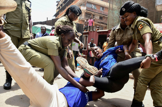 Ugandan police officers detain activists protesting the continued imprisonment of four-time presidential aspirant Kizza Besigye and other political prisoners, who were being tried by the military court, which was abolished by the Supreme Court, in Kampala, Uganda, on February 17, 2025. (Photo by Abubaker Lubowa/Reuters)