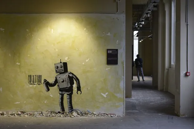 “World of Banksy”, reproductions of provocative works by the British street artist exhibited in Milan, Italy . “Robot and Barcode” is seen inside the exhibition on December 10, 2021. (Photo by Ervin Shulku/ZUMA Press Wire/Rex Features/Shutterstock)