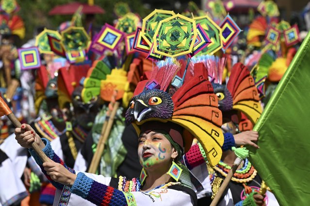 Revellers take part in the “Chant to the Earth” parade during the Carnival of Blacks and Whites in Pasto, Colombia on January 3, 2024. The Carnival has its origins in a mix of Andean, Amazonian and Pacific cultural expressions, and it celebrates the ethnic diversity in the region and was proclaimed by UNESCO as intangible cultural heritage in 2009. (Photo by Joaquin Sarmiento/AFP Photo)