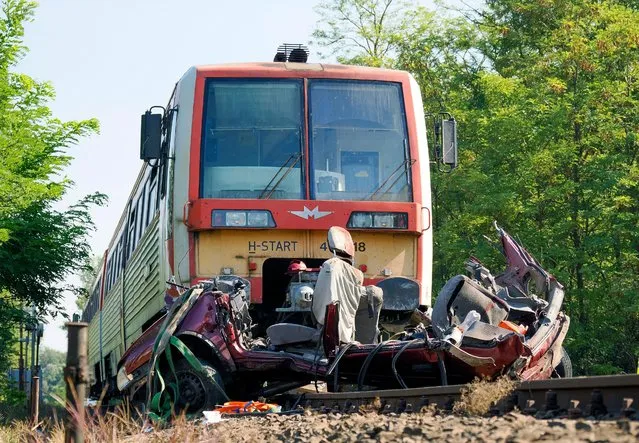 A view of the scene of an accident involving a vehicle and a passenger train, near Kunfeherto, southern Hungary, Monday, September 5, 2022. Hungarian police say seven people have been killed after a train collided with a vehicle on a railroad crossing in southern Hungary. Police said the crash occurred at a dirt road crossing around 6:45 a.m. Monday near the village of Kunfeherto. (Photo by Ferenc Donka/AP Photo)
