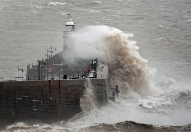 Waves crash against Folkestone harbour wall in Kent on Wednesday, January 1, 2025, as wind, rain and snow warnings are in force across parts of the UK, with the threat of flooding and disruption to New Year's Day travel. Large parts of England and Wales will be hit by strong winds until 3pm on Wednesday, while north-west England and Wales are forecast to see heavy rain for much of the morning. (Photo by Gareth Fuller/PA Images via Getty Images)