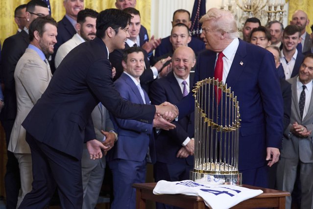 President Donald Trump shakes hands with Los Angeles Dodgers' Shohei Ohtani during a ceremony to honor the Major League Baseball 2024 World Series Champion team in the East Room of the White House, Monday, April 7, 2025, in Washington. (Photo by Evan Vucci/AP Photo)