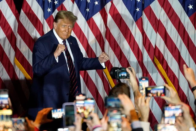 Republican presidential hopeful and former US President Donald Trump gestures during an Election Night Party in Nashua, New Hampshire, on January 23, 2024. Donald Trump won the key New Hampshire primary Tuesday, moving him ever closer to locking in the Republican presidential nomination and securing an extraordinary White House rematch with Joe Biden. (Photo by Timothy A. Clary/AFP Photo)