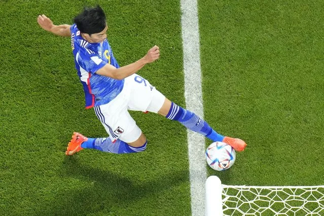 Japan's Kaoru Mitoma appears to have the ball over the line before crossing it for a goal during the World Cup group E soccer match between Japan and Spain, at the Khalifa International Stadium in Doha, Qatar, Thursday, December 1, 2022. (Photo by Petr David JosekAP Photo)