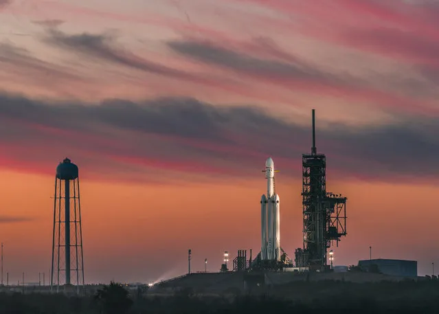 The SpaceX Falcon Heavy rocket sits on the pad at the Kennedy Space Center on February 6, 2018 ahead of its launch. The rocket weighs more than 3.1 million pounds and stands almost 230 feet high. It's designed to carry up to 140,000 pounds to low-Earth orbit, or more than 37,000 pounds all the way to Mars. (Photo by SpaceX)