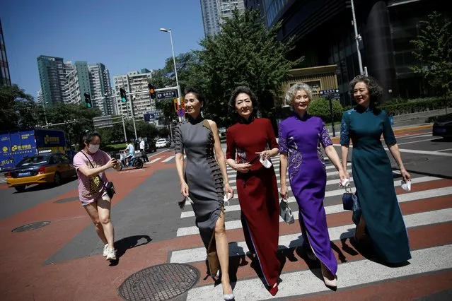 Members of an internet celebrity model group “Glamma Beijing” (L-R), Lin Wei, 65, Sun Yang, 64, Wang Nianwen, 74, and Wang Xinghuo, 70, wearing traditional Chinese dresses walk across a street during a video shooting, following the coronavirus disease (COVID-19) outbreak, in Beijing's Central Business District (CBD) area, China on August 13, 2020. (Photo by Tingshu Wang/Reuters)