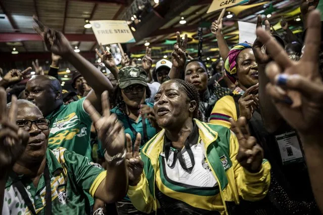 Supporters of South African President Cyril Ramaphosa celebrate after he was re-elected as African National Congress (ANC) leader during the 55th National Conference of the ANC at the  National Recreation Center (NASREC) in Johannesburg on December 19, 2022. Ramaphosa garnered 2,476 votes for the post of party president against 1,897 for former health minister Zweli Mkhize, the African National Congress' elections chief, Kgalema Motlanthe, announced. (Photo by Marco Longari/AFP Photo)